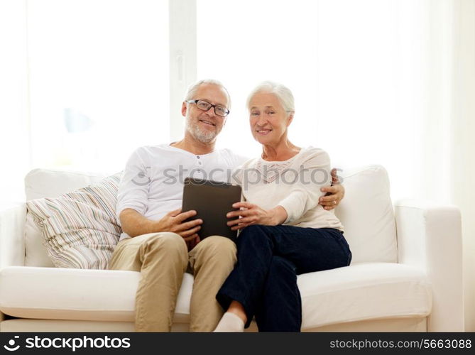 family, technology, age and people concept - happy senior couple with tablet pc computer at home