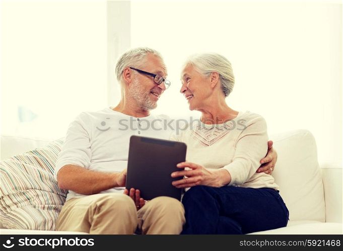 family, technology, age and people concept - happy senior couple with tablet pc computer at home