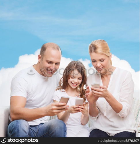 family, technology and people concept - smiling mother, father and little girl with smartphones over blue sky and white cloud background