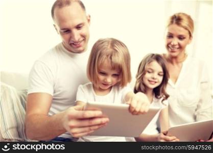 family, technology and people - happy parents and children with tablet pc computers sitting on couch at home