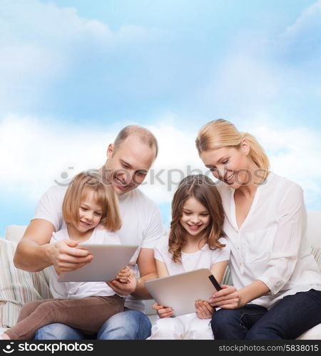 family, technology and people - smiling mother, father and little girls with tablet pc computers over blue sky background