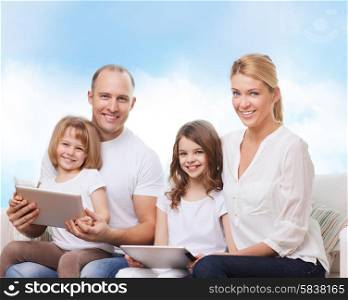 family, technology and people - smiling mother, father and little girls with tablet pc computers over blue sky background