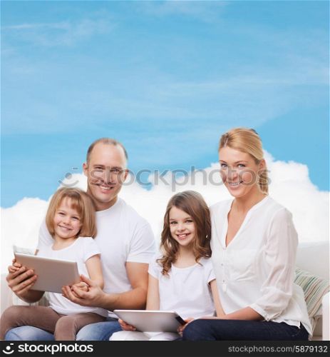 family, technology and people - smiling mother, father and little girls with tablet pc computers over blue sky and white cloud background