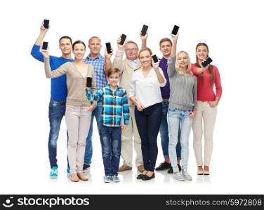family, technology, generation and people concept - group of smiling men, women and boy smartphones