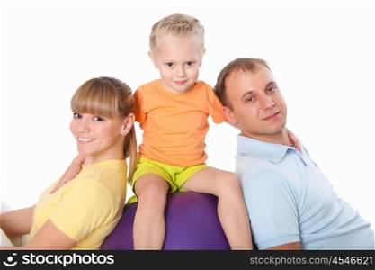 family together doing sport indoors in sportwear