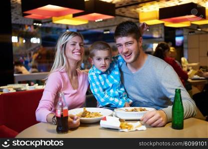 family together have break at lunch in shopping mall