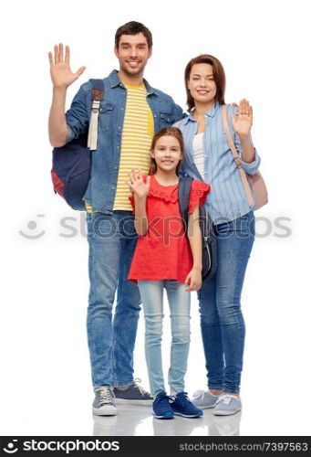 family, tourism and travel concept - happy smiling mother, father and little daughter with backpacks waving hands over white background. happy family with backpacks waving hands