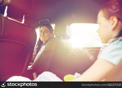 family, transport, road trip and people concept - happy woman with little daughter driving in car. happy family with little child driving in car
