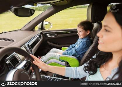 family, transport, road trip and people concept - happy woman with little girl driving in car