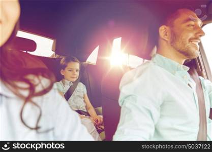 family, transport, safety, road trip and people concept - happy man and woman with little child driving in car. happy family with little child driving in car