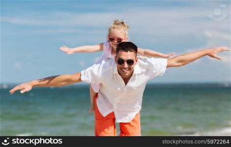 family, travel, vacation, adoption and people concept - happy father with little girl in sunglasses having fun on summer beach