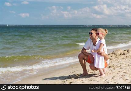 family, travel, vacation, adoption and people concept - happy father with little girl in sunglasses walking on summer beach