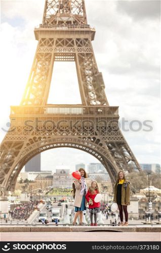 family trip. Happy mom and daughters on the background of the Eiffel Tower in Paris. France