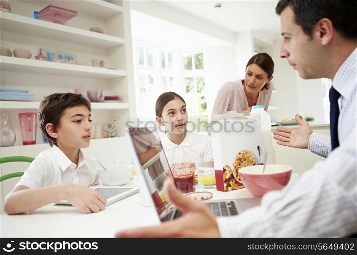 Family Using Digital Devices Having Argument Over Breakfast