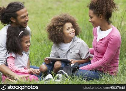 Family Using Digital Tablet Whilst Hiking In Countryside