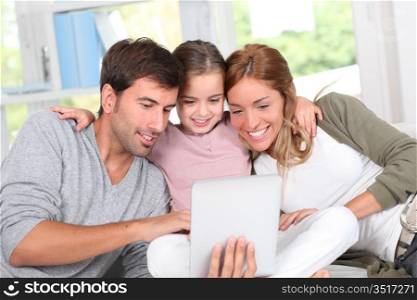 Family using electronic tablet at home