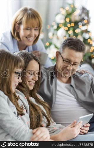 Family using tablet PC together at home