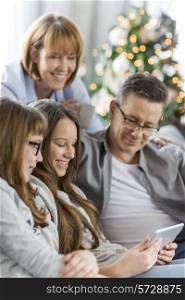 Family using tablet PC together at home