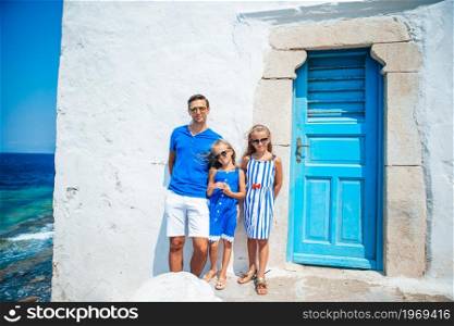 Family vacation in Europe. Father and kids background Mykonos town in Greece. Family having fun outdoors on Mykonos island