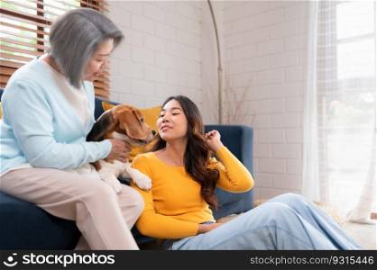 Family vacation, mother, daughter, and beagle puppy relaxing on weekends in the house&rsquo;s leisure room