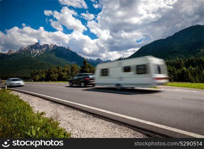 Family vacation travel, holiday trip in motorhome, caravan car motion blur. Family vacation travel, holiday trip in motorhome RV, Caravan car Vacation. Beautiful Nature Italy natural landscape Alps. Warning - authentic shooting there is a motion blur.