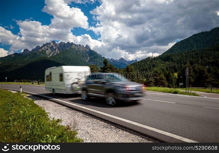 Family vacation travel, holiday trip in motorhome, caravan car motion blur. Family vacation travel, holiday trip in motorhome RV, Caravan car Vacation. Beautiful Nature Italy natural landscape Alps. Warning - authentic shooting there is a motion blur.