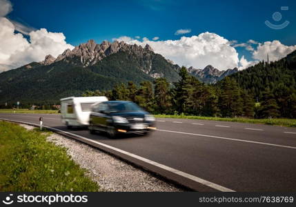 Family vacation travel, holiday trip in motorhome RV, Caravan car Vacation. Beautiful Nature Italy natural landscape Alps. Warning - authentic shooting there is a motion blur.