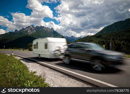 Family vacation travel, holiday trip in motorhome RV, Caravan car Vacation. Beautiful Nature Italy natural landscape Alps. Warning - authentic shooting there is a motion blur.