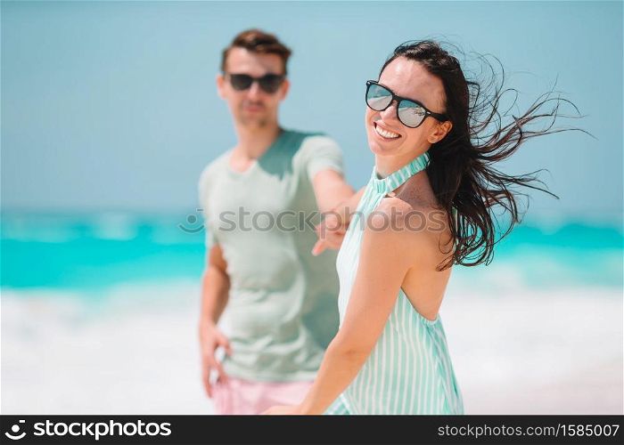Family vacation. Young couple enjoy beach holiday. Young couple on white beach during summer vacation.