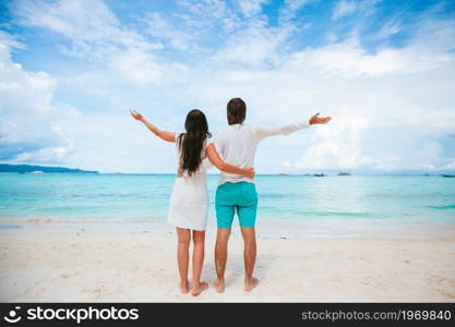 Family vacation. Young couple enjoy beach holiday. Young couple on white beach during summer vacation.