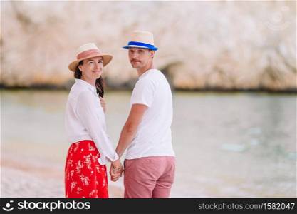 Family vacation. Young couple enjoy beach vacation. Young couple on white beach during summer vacation.