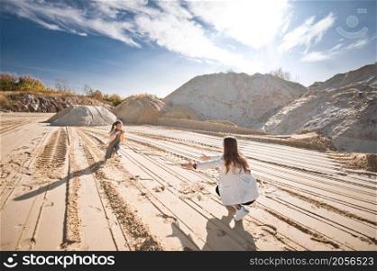 Family walk among the sand.. Mom and daughter are running among the mountains of sand 3322.