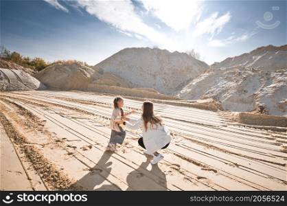 Family walk among the sand.. Mom and daughter are running among the mountains of sand 3324.