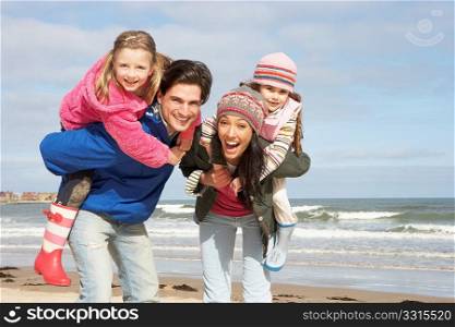 Family Walking Along Winter Beach