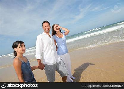 Family walking by the beach in summer