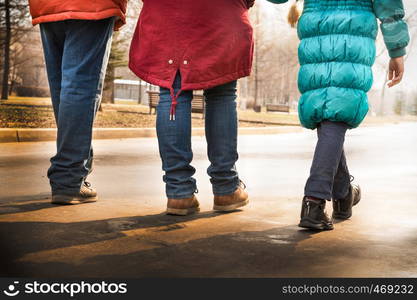 family walking on the boulevard view from the back