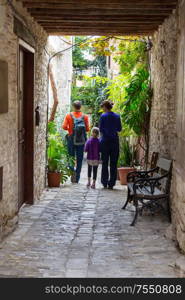 Family walking on the street in old european town