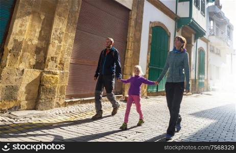 Family walking on the street in old european town
