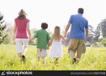 Family walking outdoors holding hands