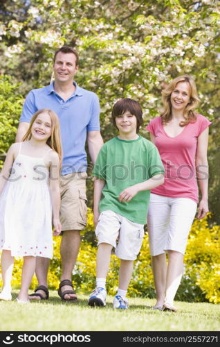 Family walking outdoors smiling