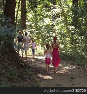 Family walking through forest in Costa Rica