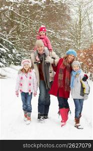 Family Walking Through Snowy Woodland