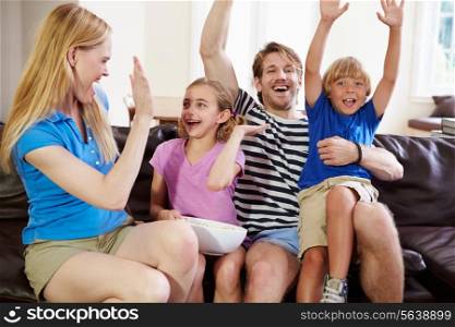 Family Watching Soccer on TV Celebrating Goal