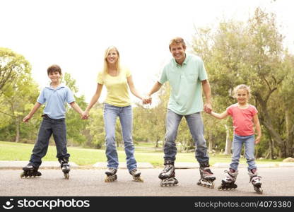 Family Wearing In Line Skates In Park
