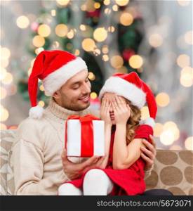 family, winter holidays and people concept - smiling daughter with closed eyes waiting for present from father over living room and christmas tree background