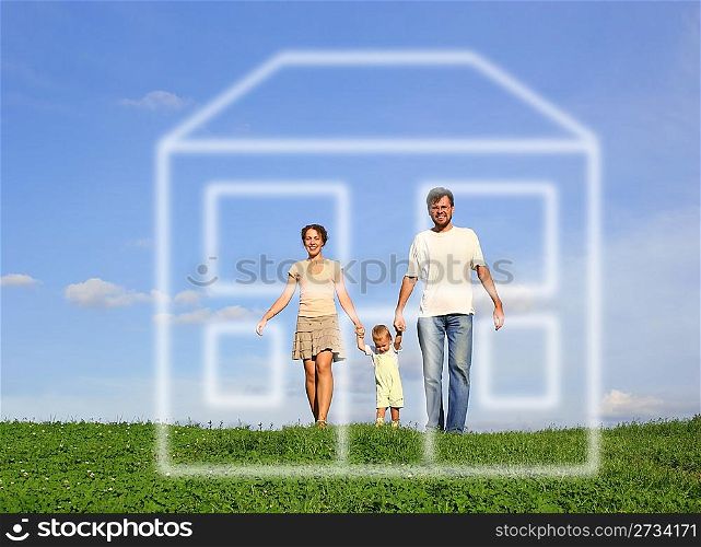 family with baby walking on grass