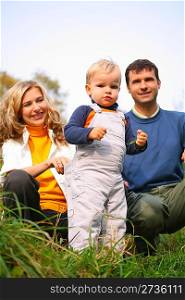 family with boy in grass