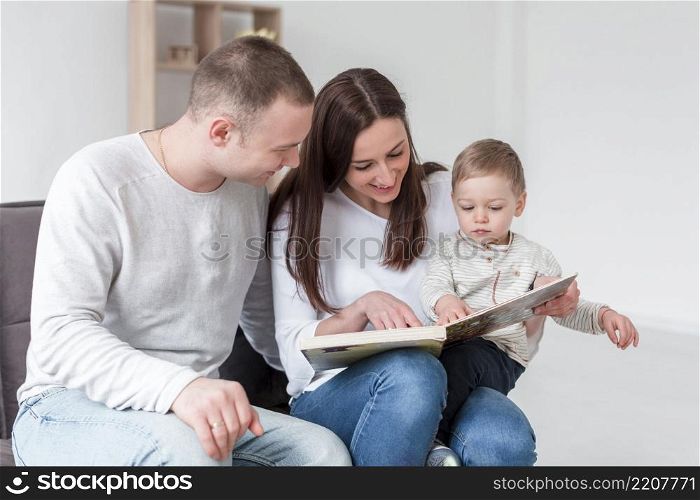 family with child book home