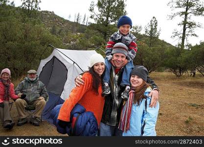Family with children (7-12) camping (portrait)