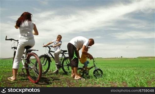 family with children having a weekend excursion on their bikes